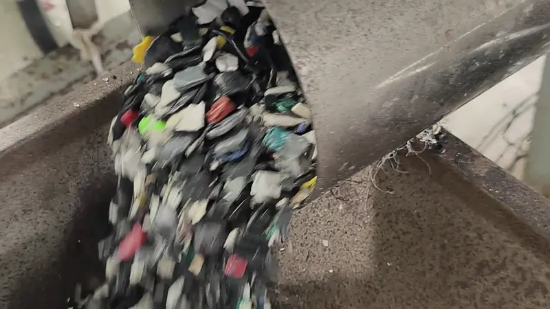Crushed flakes pour out of a chute