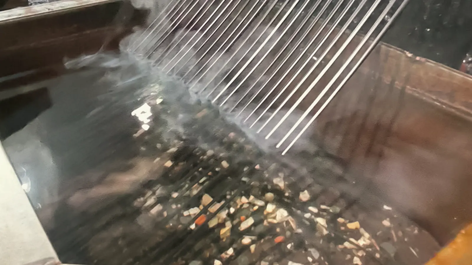 Molten plastic strands leaving the extruder into the cooling water, from Dayatas Profab's production footage