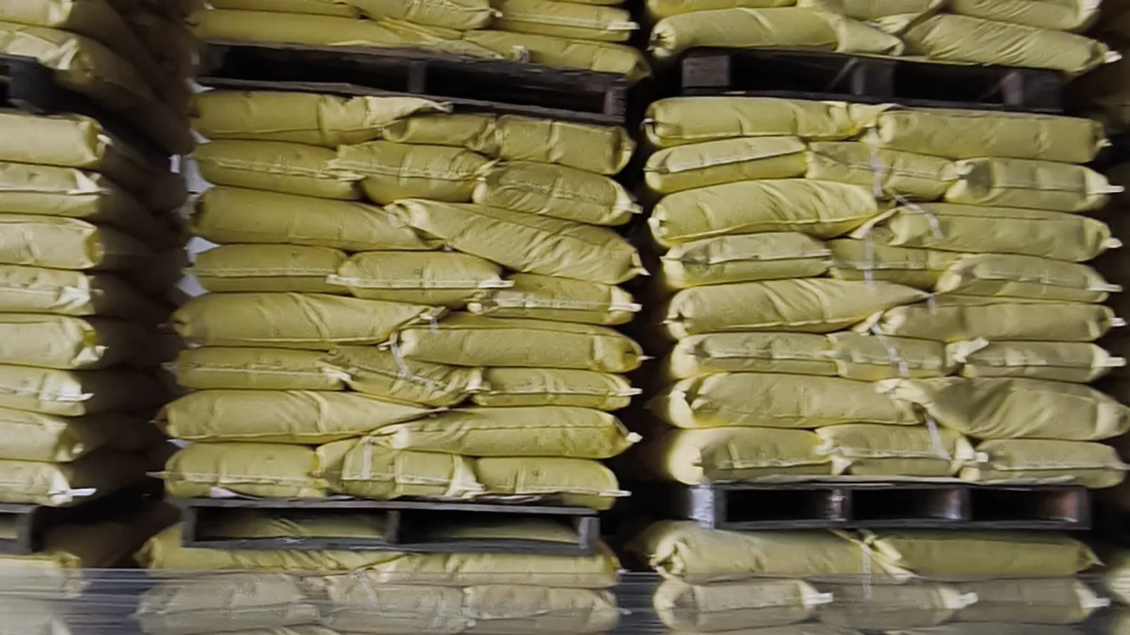 Pallets of bagged resin, stacked in rows